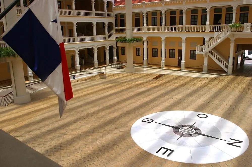Inner courtyard of Palacio Bolívar with a compass rose drawn on the floor and the flag of Panama